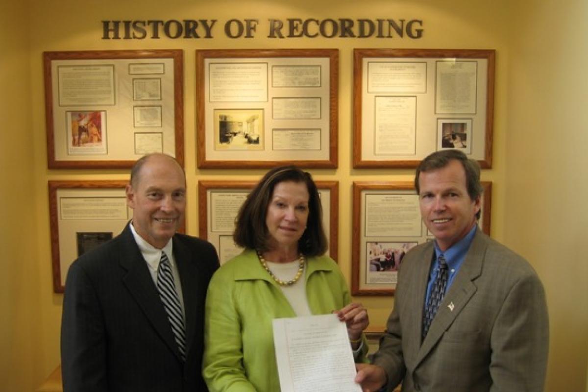 Register Buckley and Register O'Donnell stand with Senate President Murray with a copy of the newly signed legislation changing the recording statute.